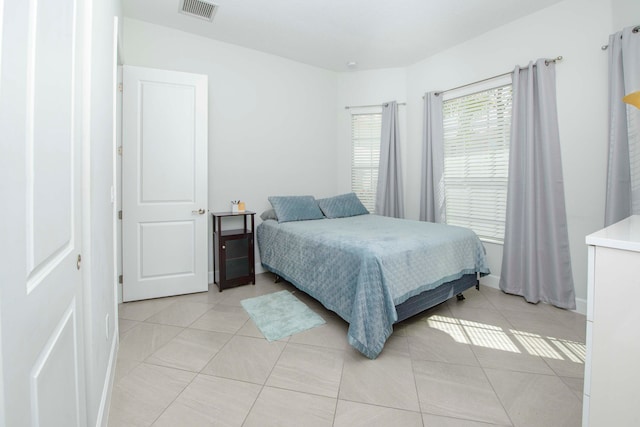 bedroom with light tile patterned floors