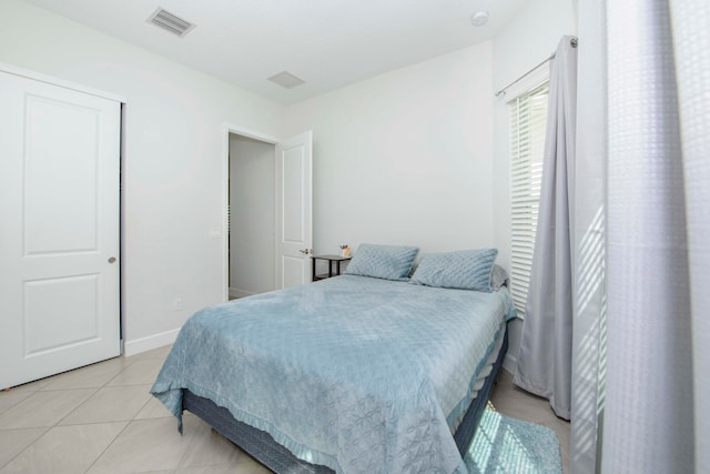 bedroom with light tile patterned floors