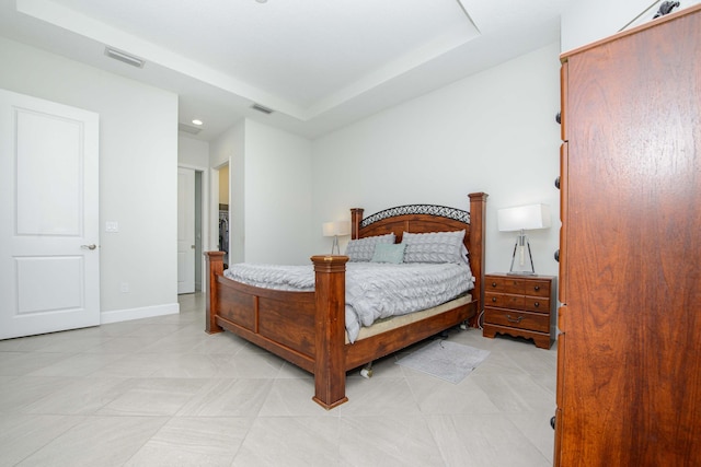 tiled bedroom with a tray ceiling