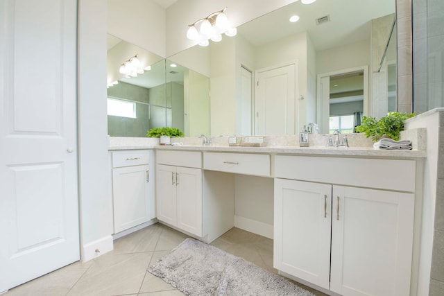 bathroom with dual vanity and tile patterned flooring