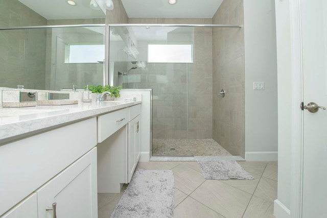 bathroom with double sink vanity, a shower with shower door, and tile patterned floors