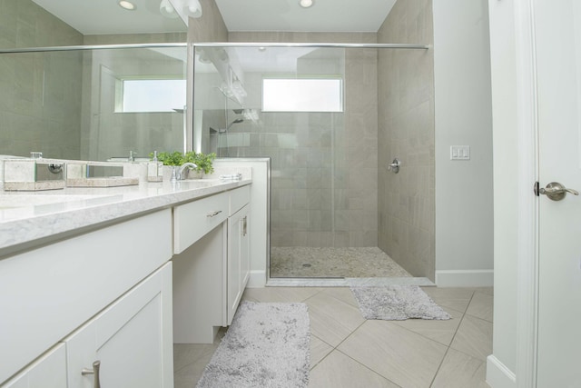 bathroom with tile patterned flooring, vanity, and a shower with shower door