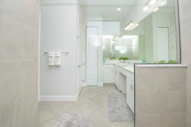 bathroom with vanity, tile walls, and tile patterned flooring