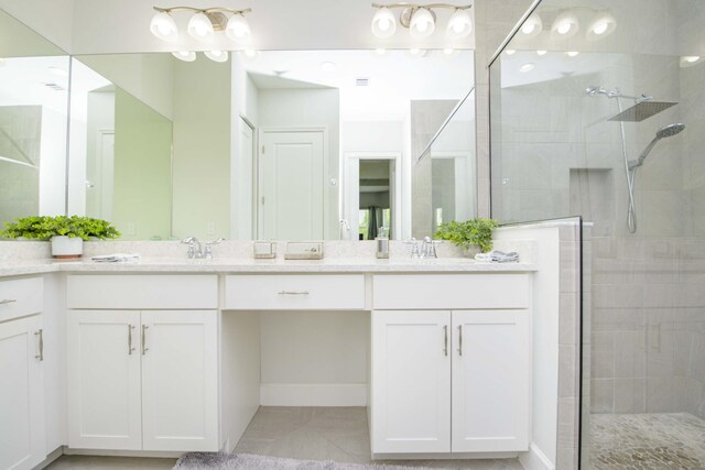 bathroom with an enclosed shower, tile patterned floors, and double vanity