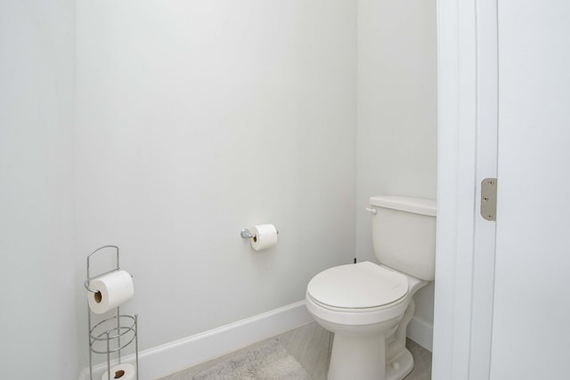 bathroom featuring toilet and tile patterned flooring