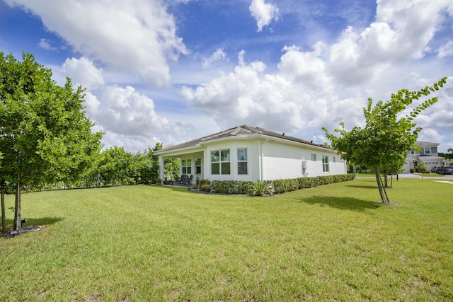 view of property exterior with a yard