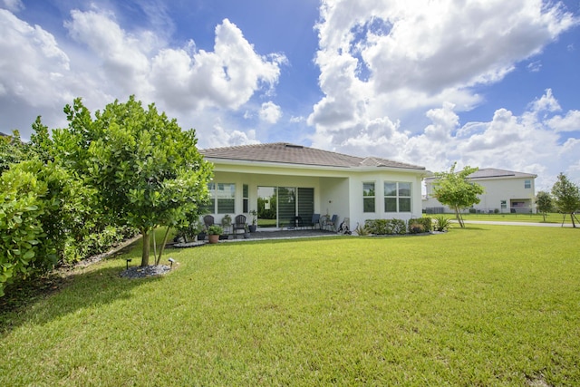 back of house featuring a yard and a patio area