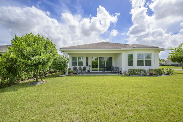 rear view of property featuring a yard