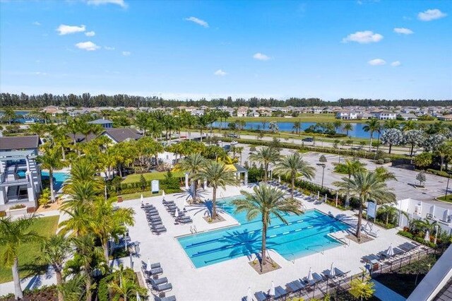 view of swimming pool featuring a patio area and a water view