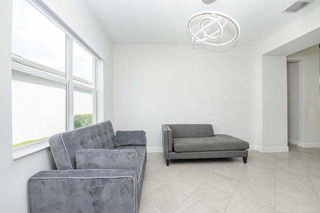 living room featuring light tile patterned flooring and a chandelier