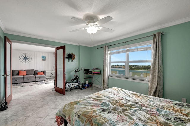 tiled bedroom with a water view, ceiling fan, and ornamental molding