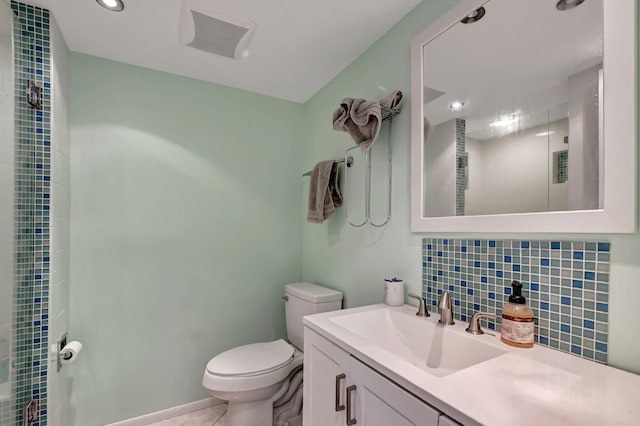 bathroom featuring walk in shower, toilet, vanity, tile patterned flooring, and backsplash