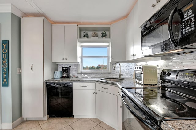 kitchen with sink, white cabinetry, tasteful backsplash, light tile patterned floors, and black appliances