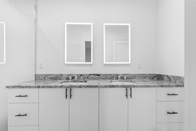 bathroom featuring double vanity and a sink