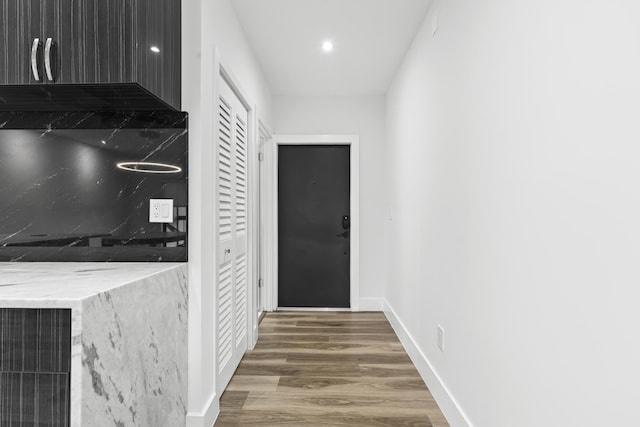 interior space with light countertops, dark wood-type flooring, recessed lighting, and baseboards