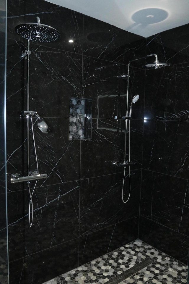 bathroom with a marble finish shower