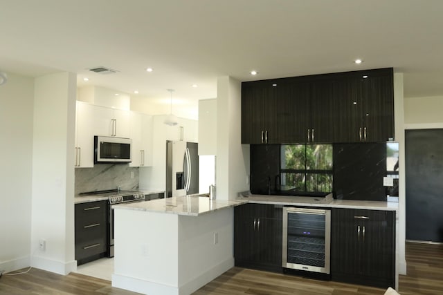 kitchen with beverage cooler, visible vents, white cabinets, light stone countertops, and stainless steel appliances