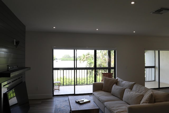 living room with wood finished floors, visible vents, and recessed lighting