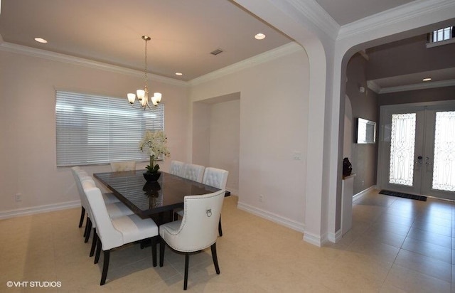 tiled dining area with a notable chandelier, ornamental molding, and french doors