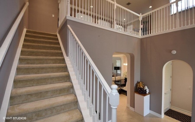 stairway featuring a high ceiling