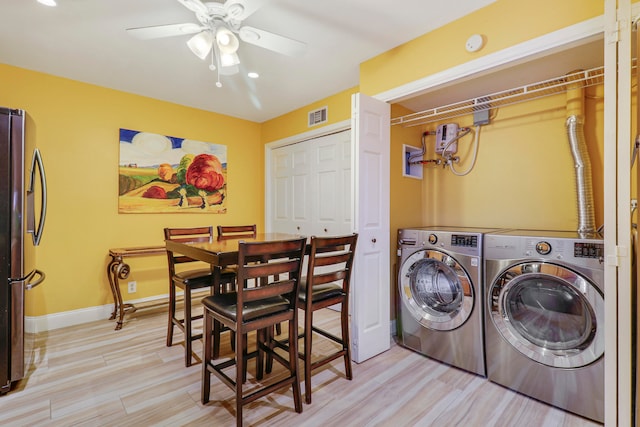 washroom featuring ceiling fan, separate washer and dryer, and light hardwood / wood-style floors