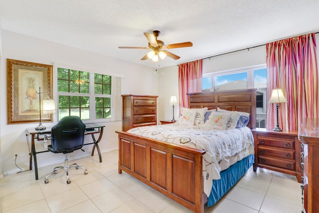 tiled bedroom with a textured ceiling, ceiling fan, and multiple windows