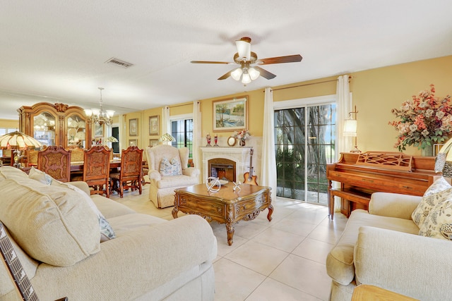 tiled living room with ceiling fan with notable chandelier