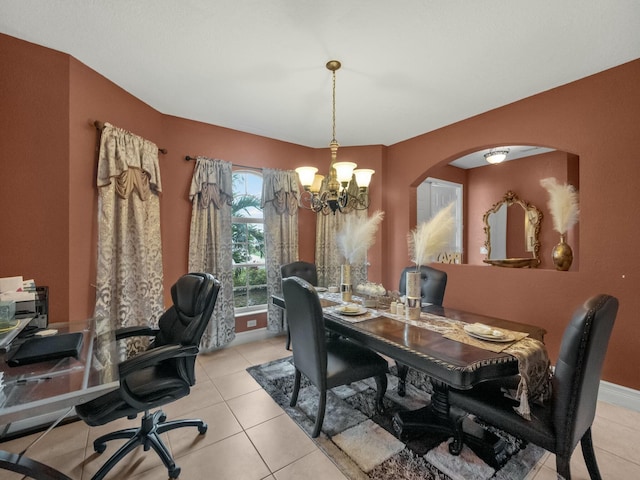 dining room with light tile patterned flooring and a chandelier