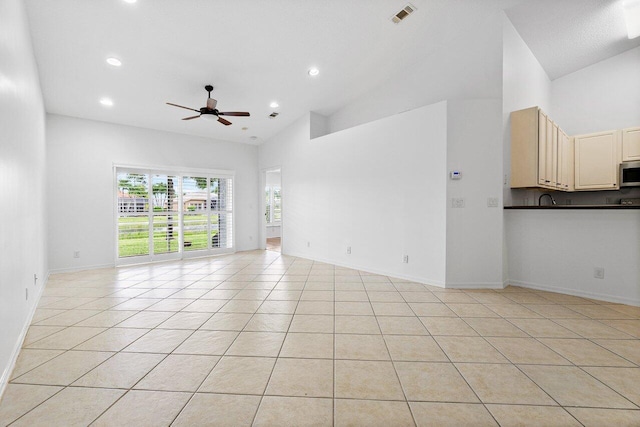 unfurnished living room featuring ceiling fan, light tile patterned floors, and high vaulted ceiling