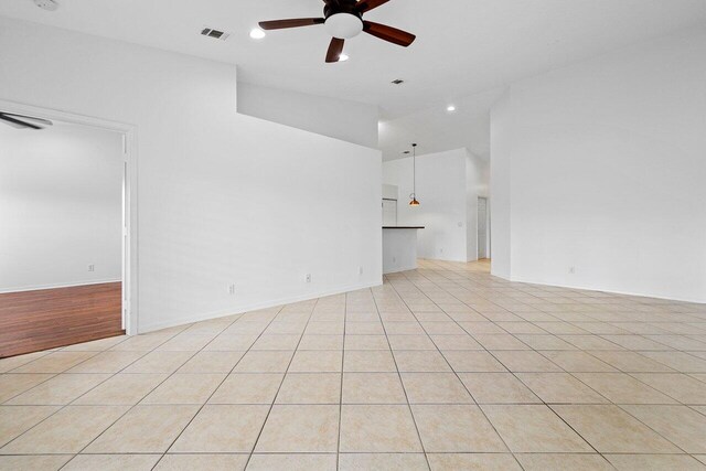 tiled empty room with ceiling fan