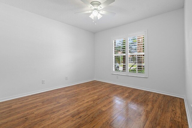 unfurnished room with ceiling fan, hardwood / wood-style floors, and a textured ceiling