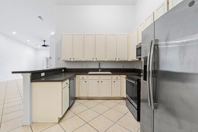 kitchen with sink, ceiling fan, light tile patterned floors, kitchen peninsula, and stainless steel appliances