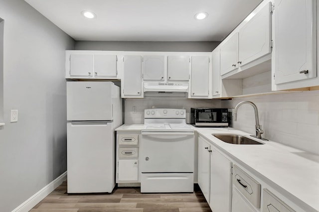 kitchen with white appliances, tasteful backsplash, sink, white cabinetry, and light hardwood / wood-style flooring