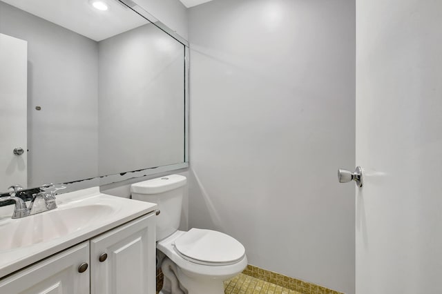 bathroom featuring vanity, toilet, and tile patterned floors