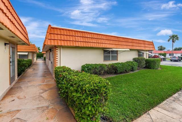 view of home's exterior with a yard