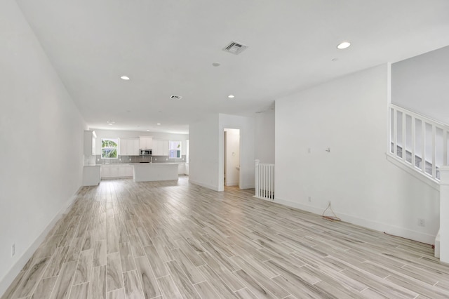 unfurnished living room featuring light hardwood / wood-style flooring