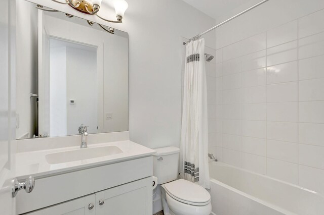 full bathroom featuring shower / tub combo with curtain, vanity, and toilet