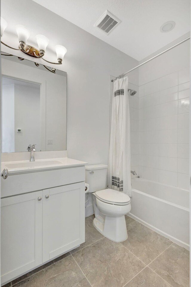 full bathroom with shower / bathtub combination with curtain, vanity, tile patterned flooring, and toilet