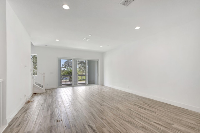 spare room with light hardwood / wood-style flooring