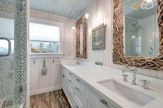 bathroom with wood walls, hardwood / wood-style flooring, dual bowl vanity, wooden ceiling, and crown molding