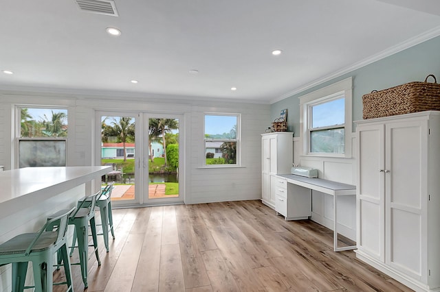 interior space featuring light hardwood / wood-style flooring and crown molding