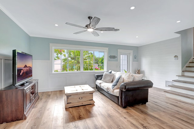 living room with ceiling fan, crown molding, and light hardwood / wood-style floors