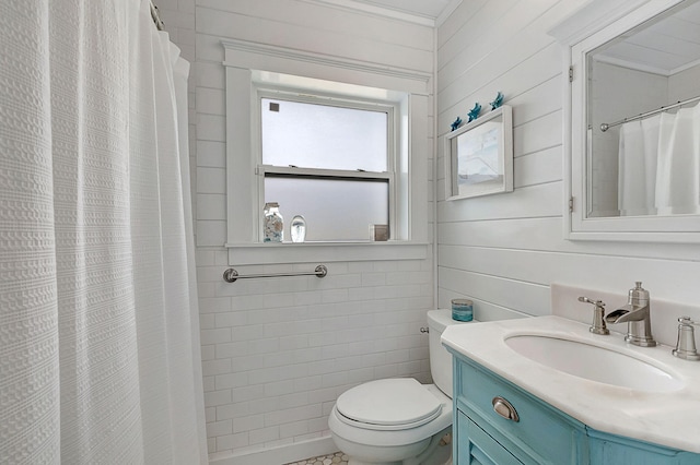 bathroom featuring toilet, crown molding, and vanity