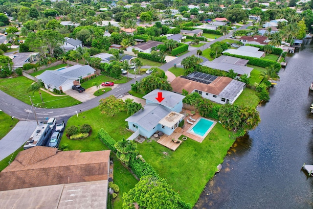 drone / aerial view with a residential view and a water view