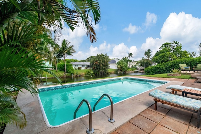 pool with a water view and a patio