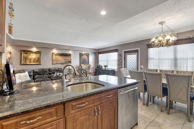 kitchen featuring dark stone countertops, a healthy amount of sunlight, decorative light fixtures, and dishwasher