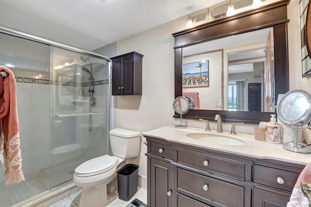 bathroom featuring tile patterned floors, vanity, toilet, and an enclosed shower