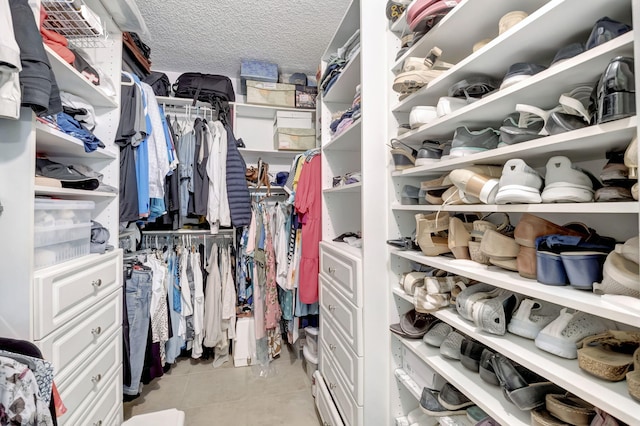 walk in closet with light tile patterned floors