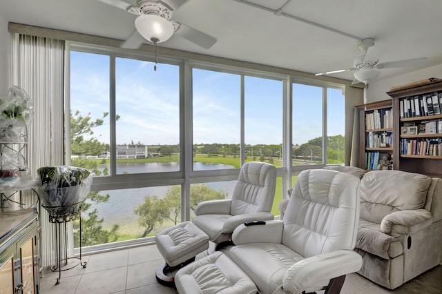 interior space with plenty of natural light, a water view, and ceiling fan