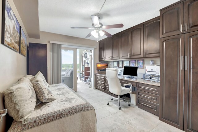 sunroom featuring a water view and ceiling fan